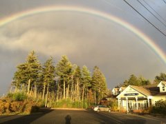 Rainbow over Creative Kids Education Centre with surrounding nature.